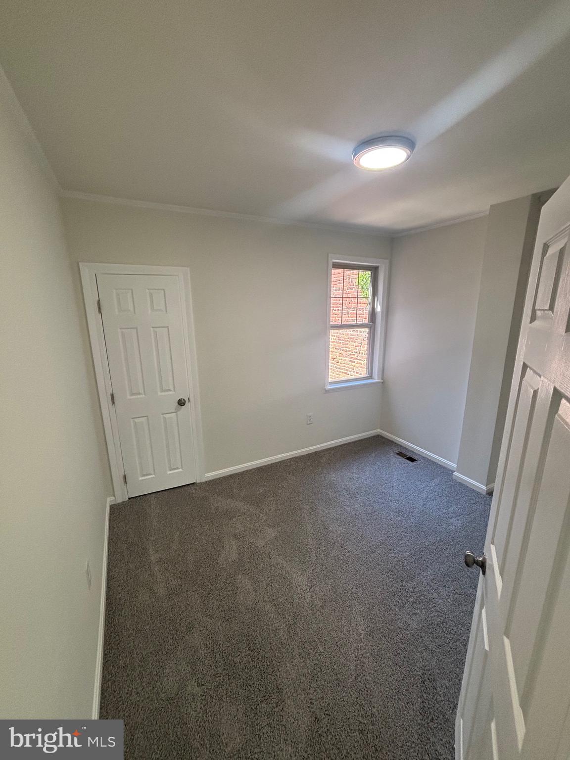 6769 Woodley Road Baltimore, MD 21222 - Photo 23 of 27 a view of an empty room and window