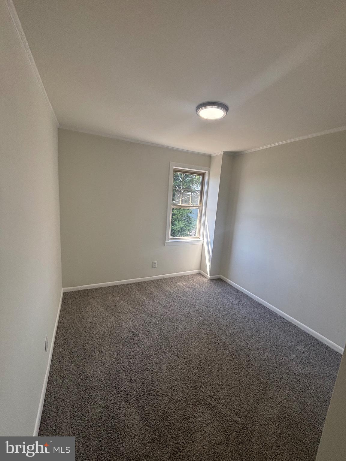 6769 Woodley Road Baltimore, MD 21222 - Photo 25 of 27 an empty room with windows and closet