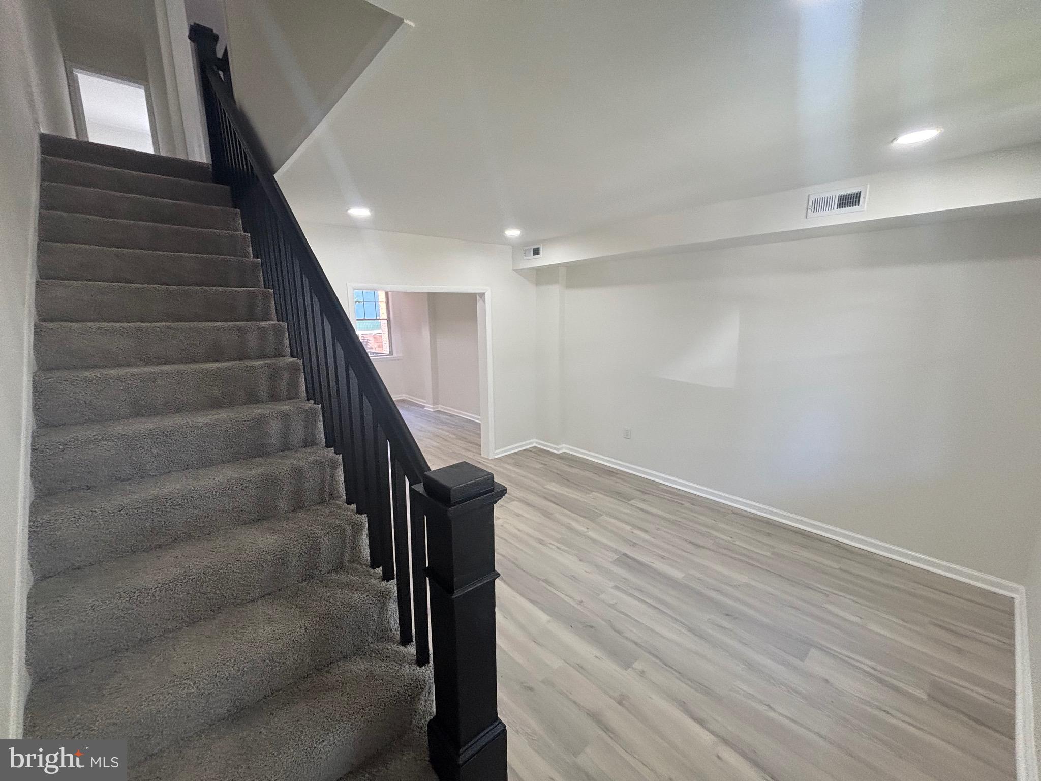 6769 Woodley Road Baltimore, MD 21222 - Photo 8 of 27 a view of entryway with stairs and wooden floor