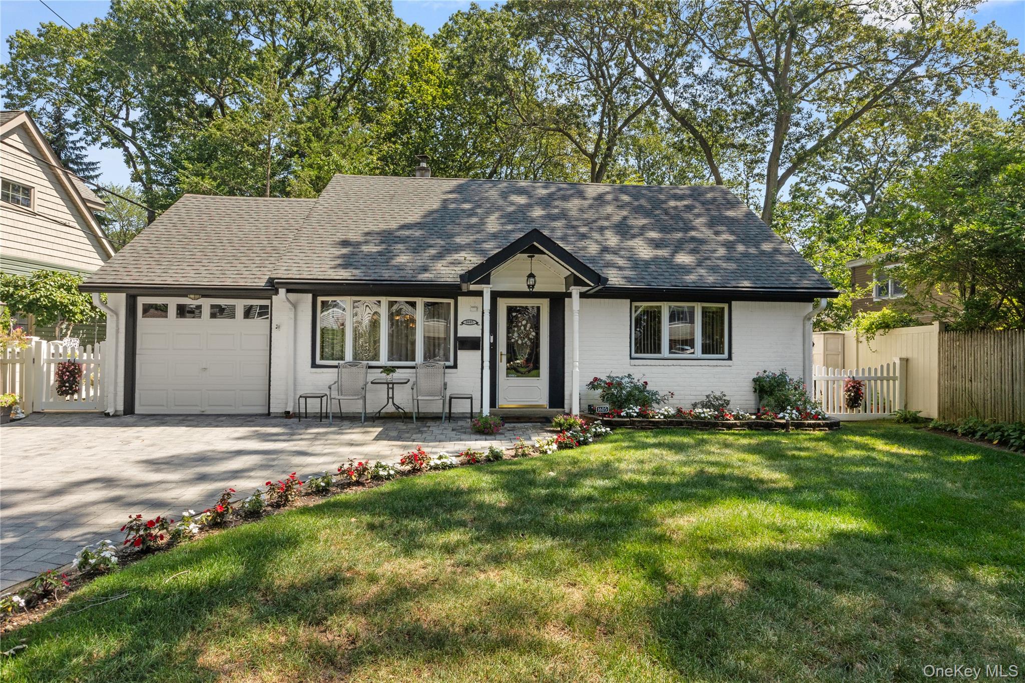 1605 Henry Road Wantagh, NY 11793 - Photo 1 of 1 a front view of a house with a garden