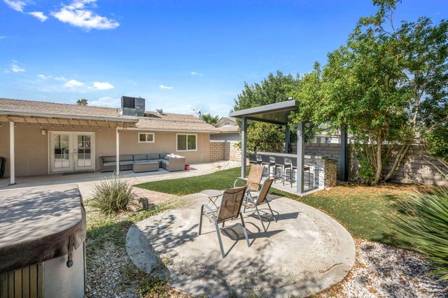 a view of a house with backyard porch and sitting area