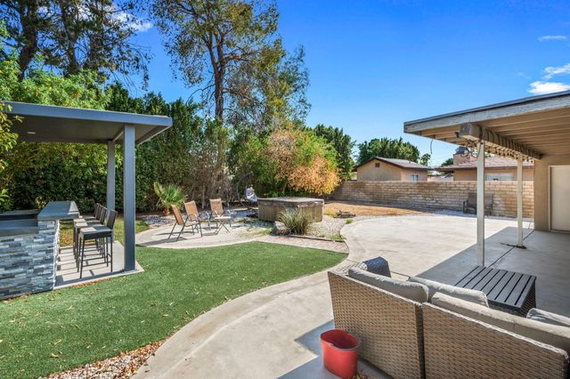 a view of a backyard with sitting area