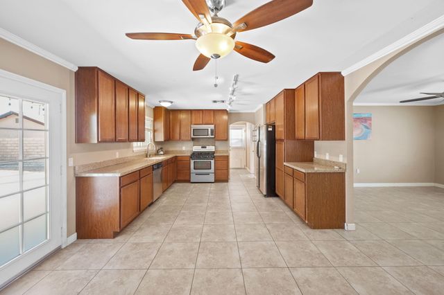 a large kitchen with cabinets and stainless steel appliances