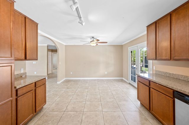 a view of a kitchen with a sink and cabinets