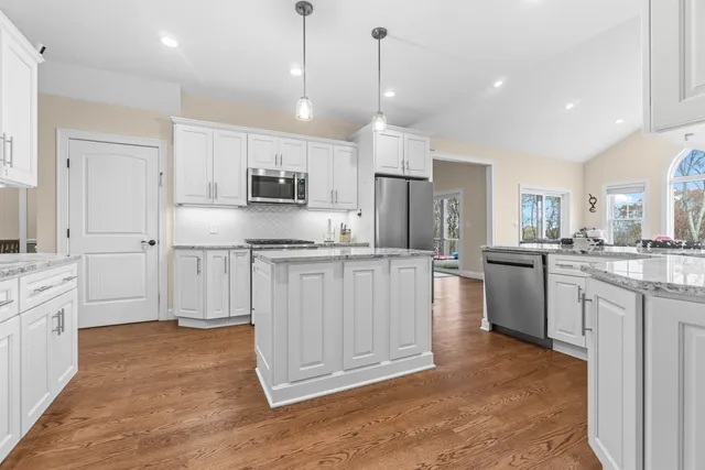 a view of a livingroom with furniture and a dining table