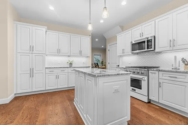a dining room with furniture and wooden floor