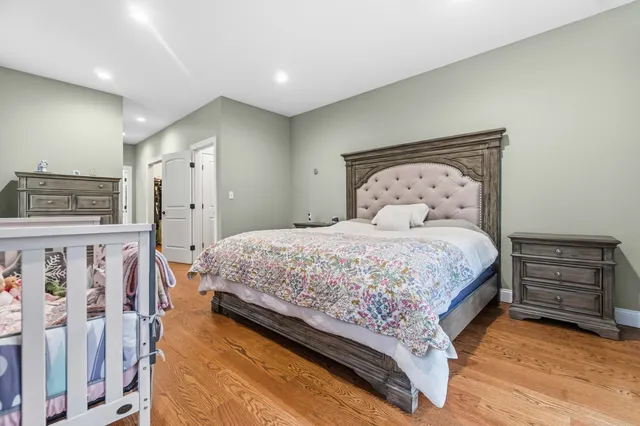 a bed sitting in a bedroom next to a window
