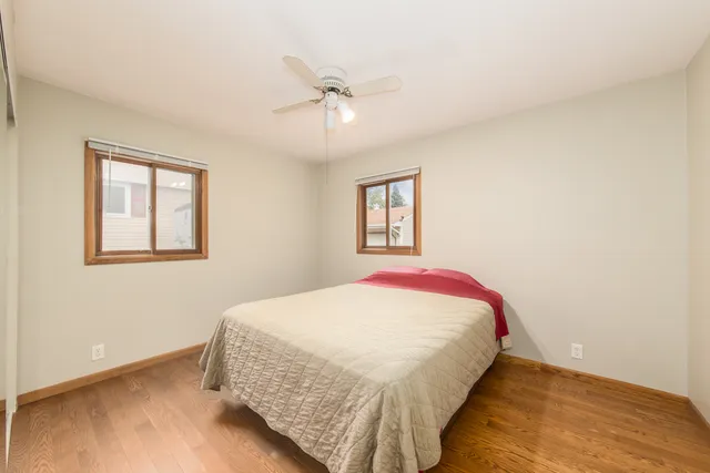 a white toilet sitting next to a white sink and a mirror