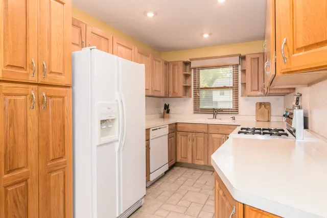 a kitchen with a refrigerator a sink and cabinets