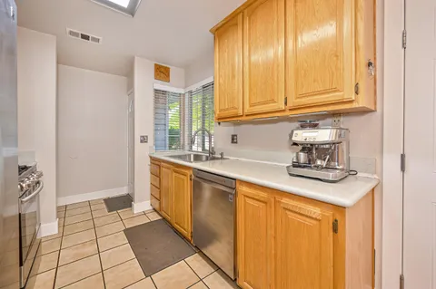 a kitchen with stainless steel appliances granite countertop a sink and cabinets
