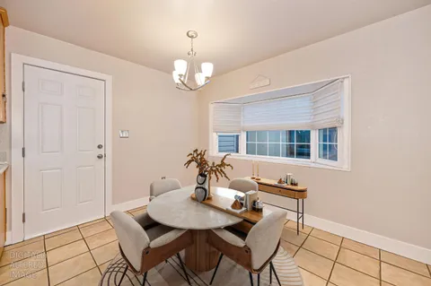 a view of a dining room with furniture wooden floor and chandelier
