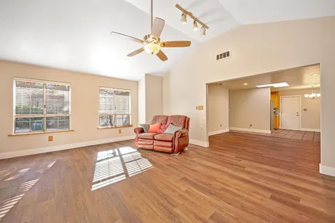 a living room with furniture and wooden floor