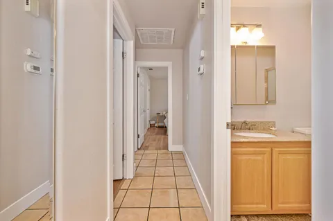 a view of a hallway view with wooden floor and staircase