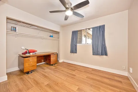a view of a room with wooden floor and windows