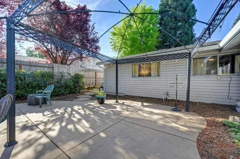 a view of a house with a yard and sitting area