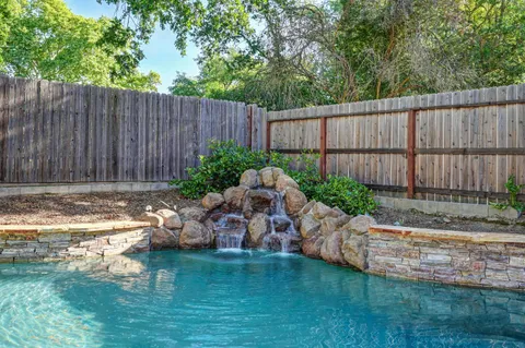 a backyard of a house with yard and outdoor seating