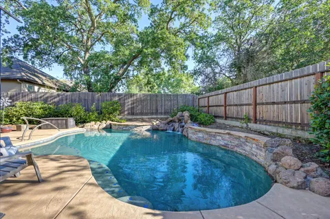 a view of a swimming pool with a patio