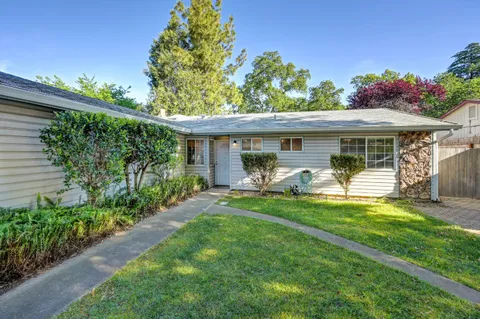 a front view of a house with garden