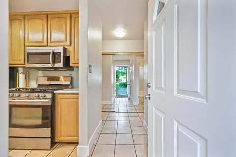 a kitchen with stainless steel appliances granite countertop a stove and a refrigerator
