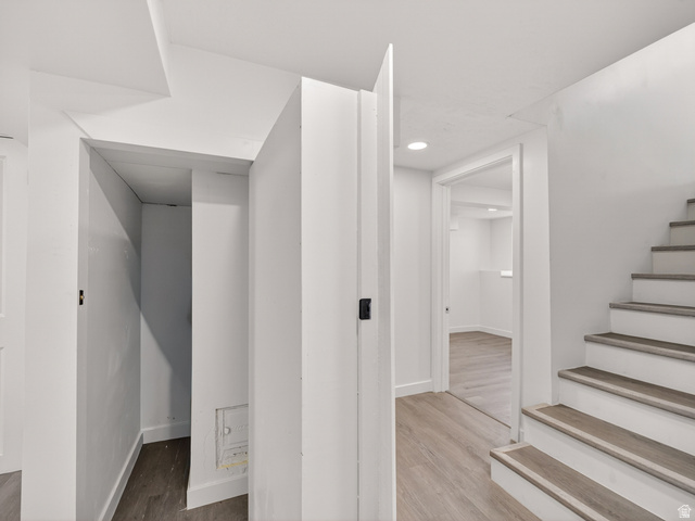 74 South 300 East Springville, UT 84663 - Photo 30 of 48 White-painted interior featuring a staircase with wood-finish treads, a partial doorway to an interior room, and recessed lighting