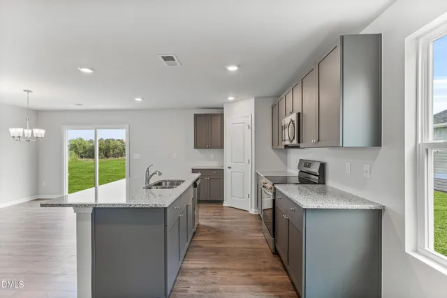 a kitchen with a sink stove and cabinets