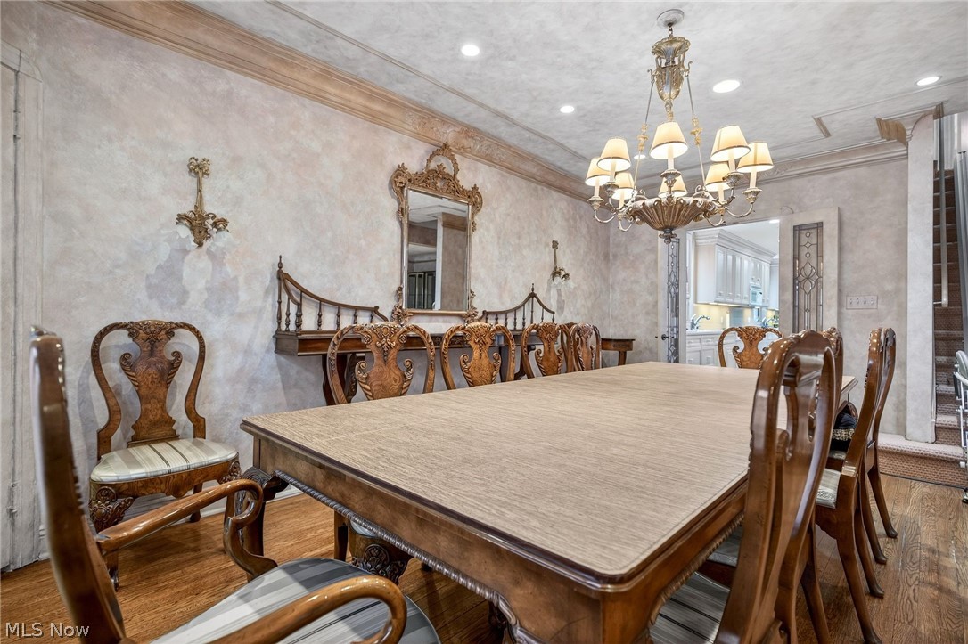 3498 Bainbridge Road Cleveland Heights, OH 44118 - Photo 10 of 50 Dining area with wood finished floors, ornamental molding, and a chandelier