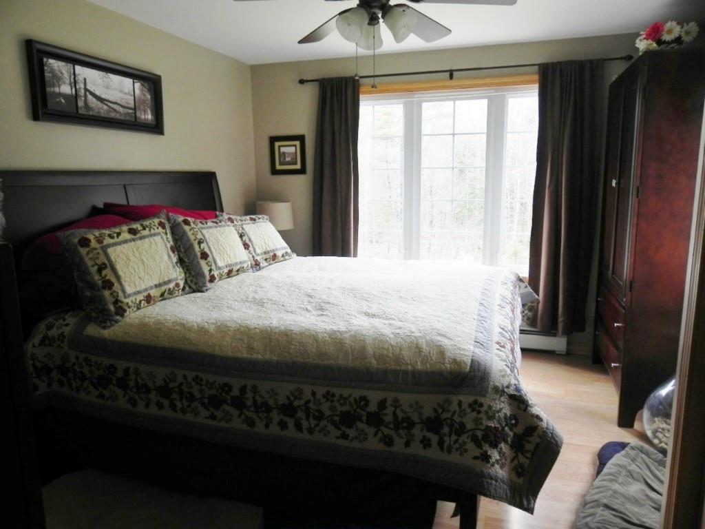 89 Peaked Mountain Road Sebago, ME 04029 - Photo 13 of 34 Master bedroom with large windows...