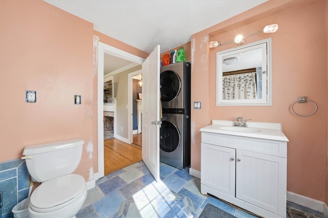 32 Equestrian Way Cranston, RI 02921 - Photo 50 of 50 Conveniently located just off the living room, this first-floor full bath also incorporates a stacked laundry center and direct access to the side and backyard. A tub-and-shower combination and distinctive tile flooring add everyday practicality to the farmhouse floor plan.