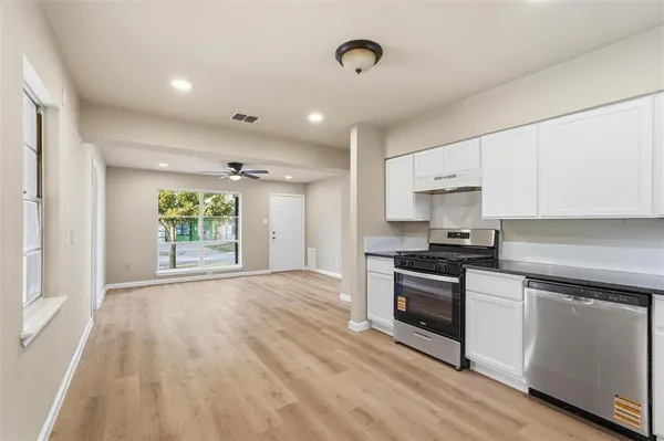 a kitchen with a stove a sink and a refrigerator