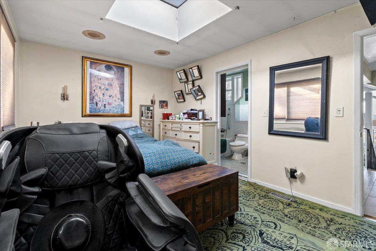 130 Ripley Street San Francisco, CA 94110 - Photo 20 of 69 a bedroom with a bed and wooden floor