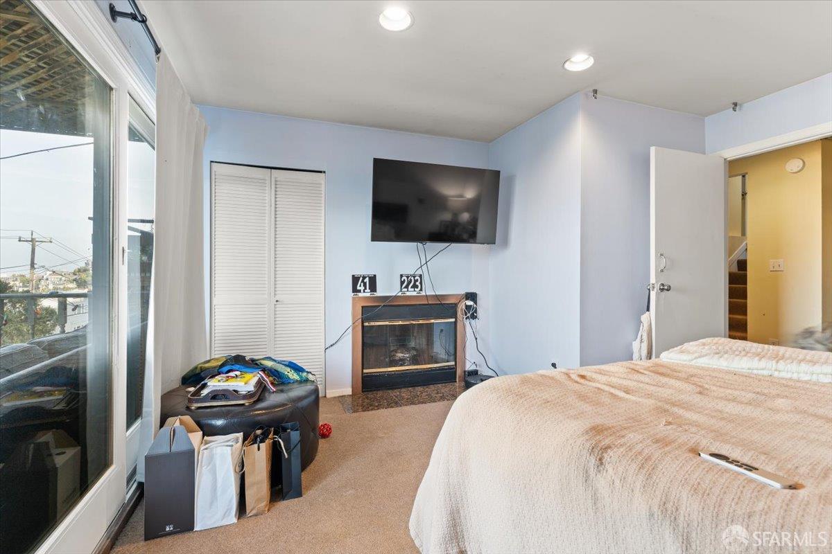 130 Ripley Street San Francisco, CA 94110 - Photo 35 of 69 a bedroom with a bed and a flat screen tv