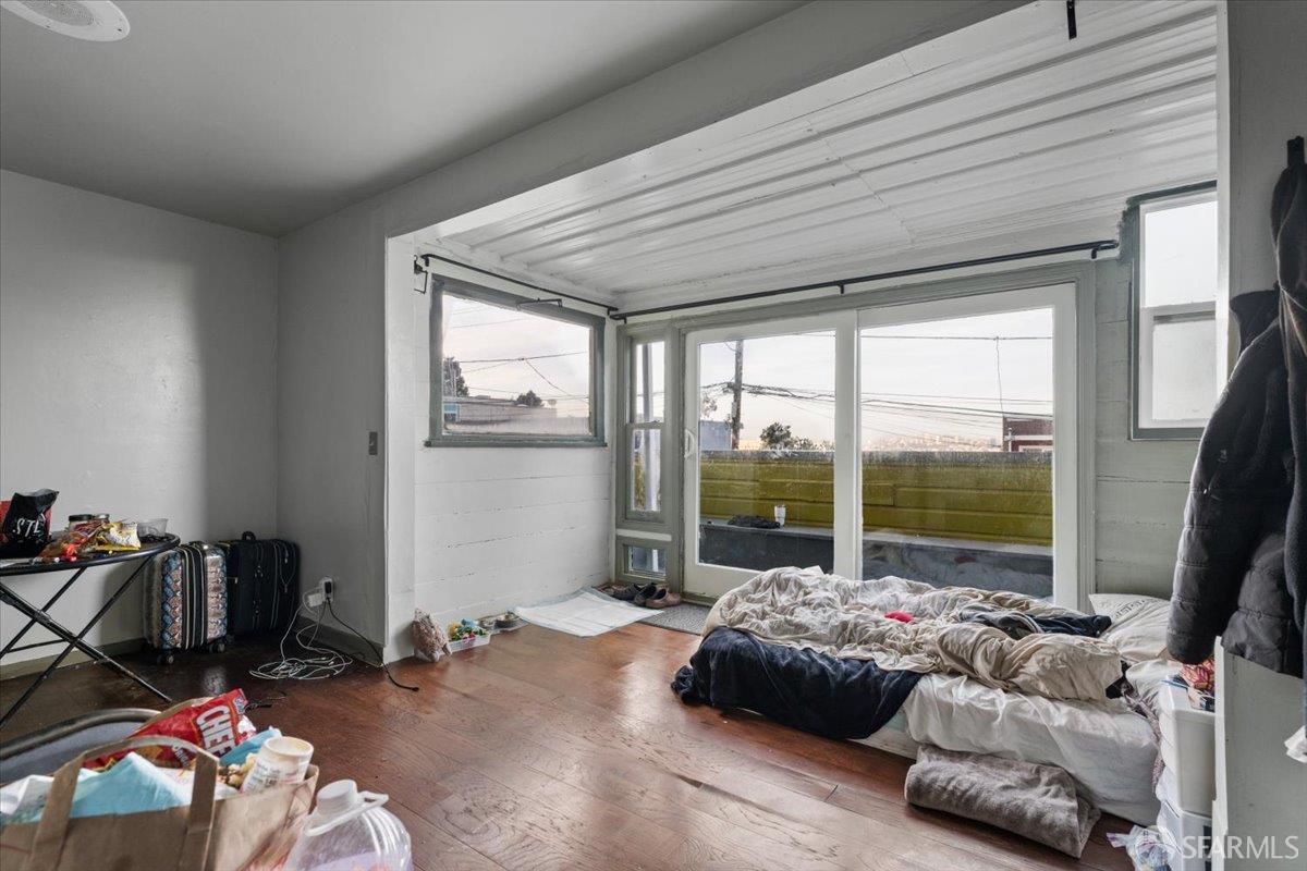 130 Ripley Street San Francisco, CA 94110 - Photo 52 of 69 a bedroom with a bed and glass window