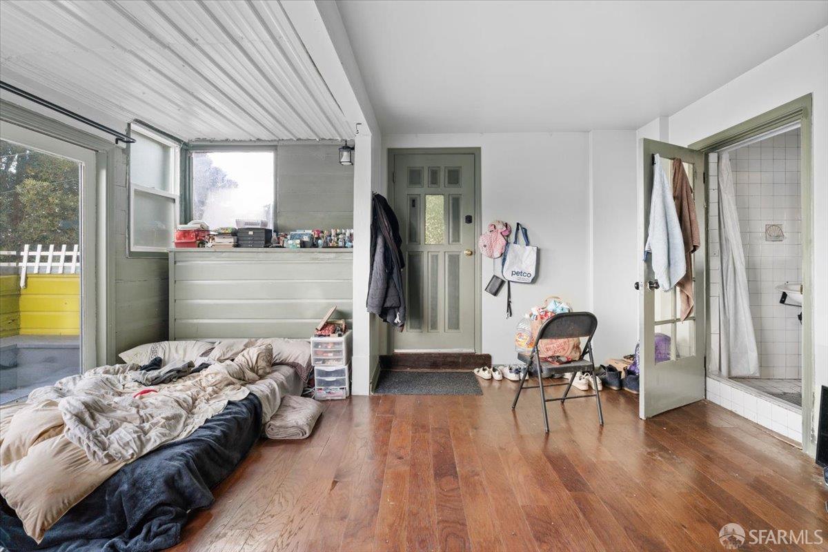 130 Ripley Street San Francisco, CA 94110 - Photo 57 of 69 a bedroom with furniture and a wooden floor