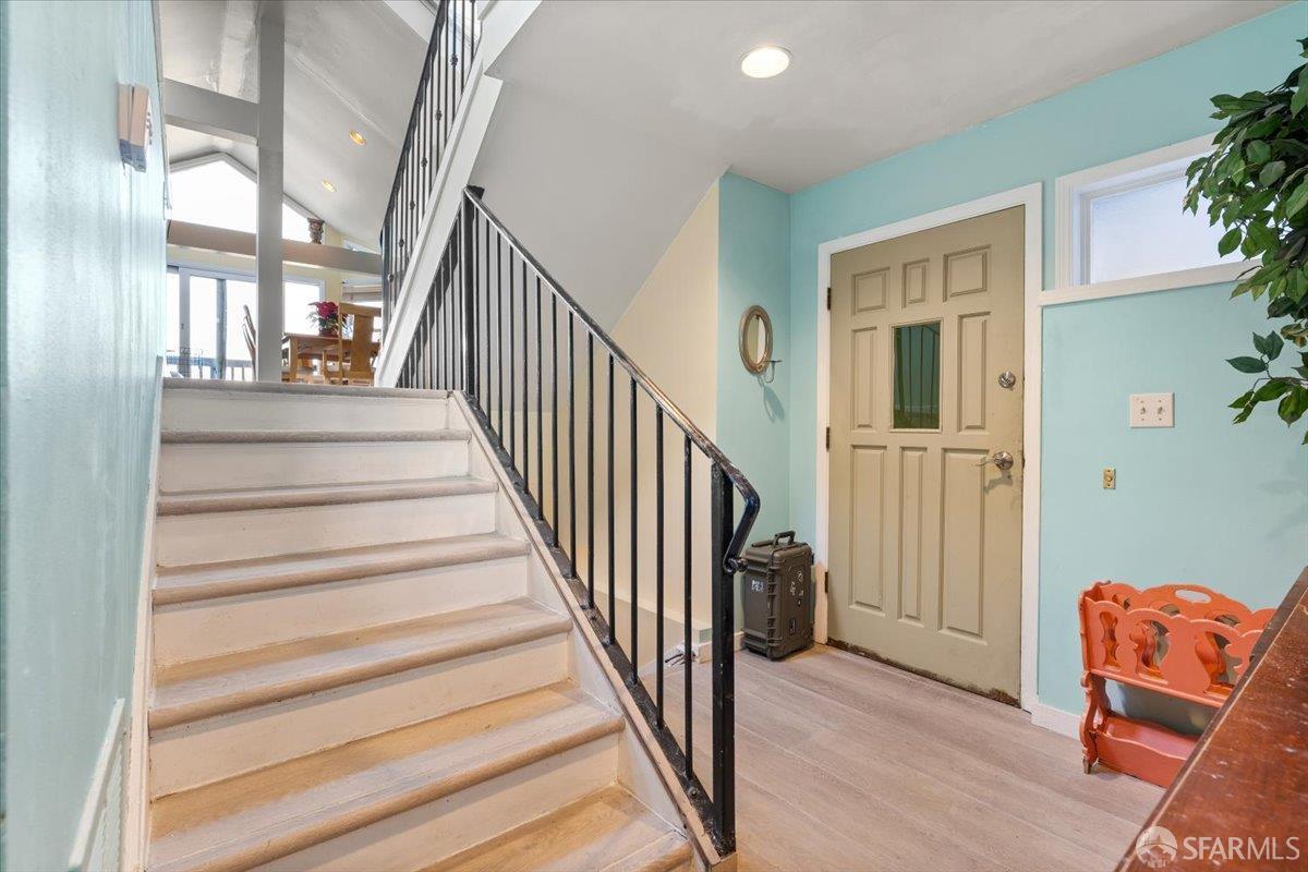 130 Ripley Street San Francisco, CA 94110 - Photo 8 of 69 a view of staircase with lots of frames on wall and a window