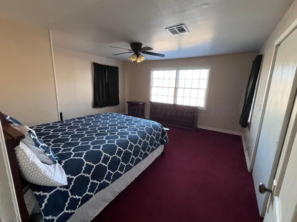 a bedroom with a bed and window