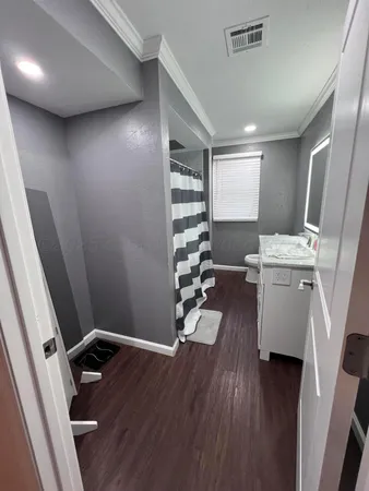 a view of a hallway with workspace and wooden floor
