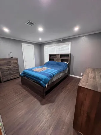 a bedroom with a bed and a night stand