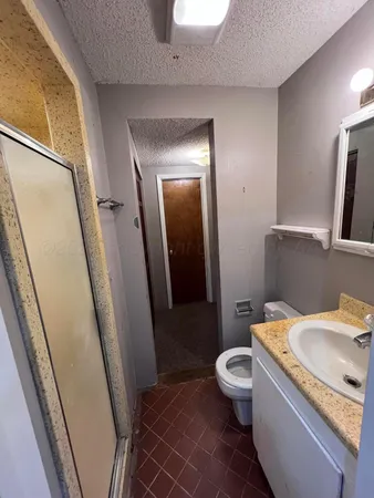 a white toilet sitting next to a bathroom sink