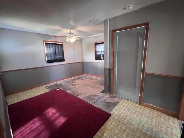 a bedroom with a bed and a mirror