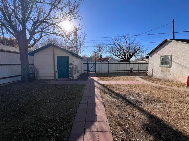 a backyard of a house with large trees