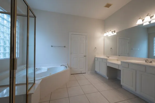 a bathroom with a bathtub and a shower