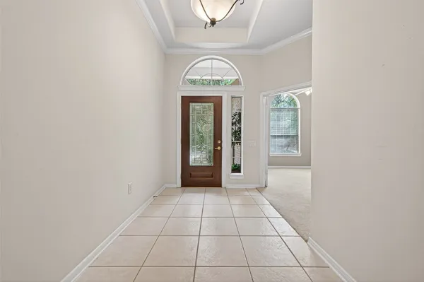 an empty room with a window and a mirror