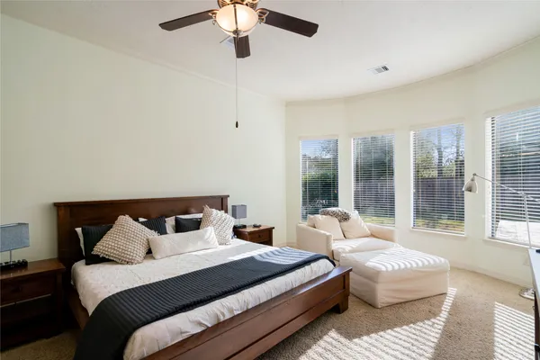 a bedroom with bed and large window
