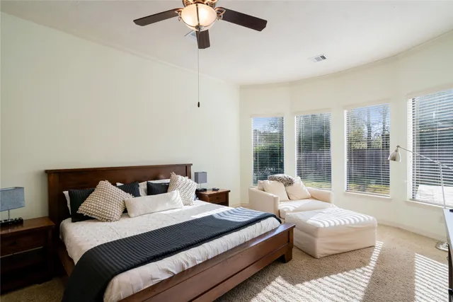 a bedroom with bed and large window