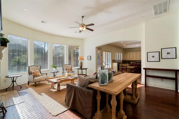 a living room with furniture a table and a large window
