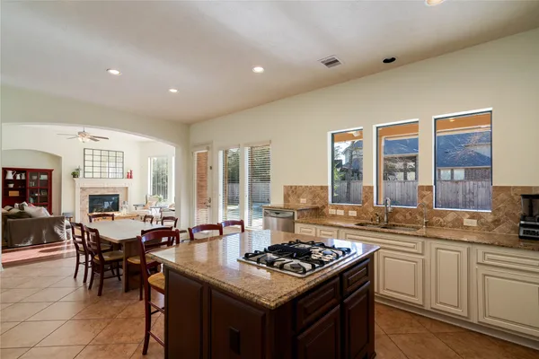 a kitchen with a stove a sink a refrigerator and a dining table