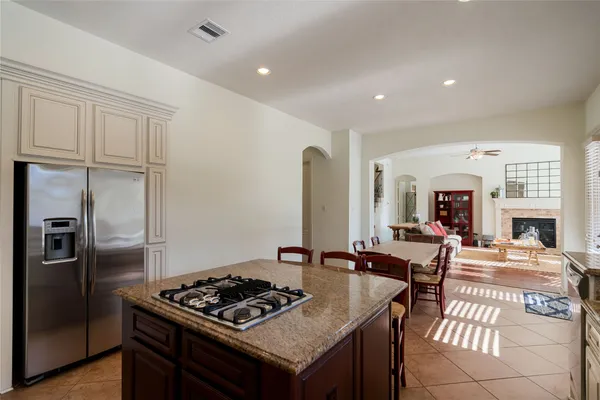 a kitchen that has a stove and a table in it