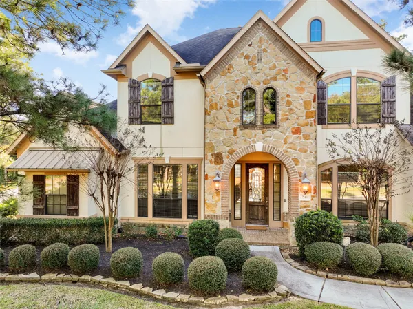 a view of a brick house with large windows