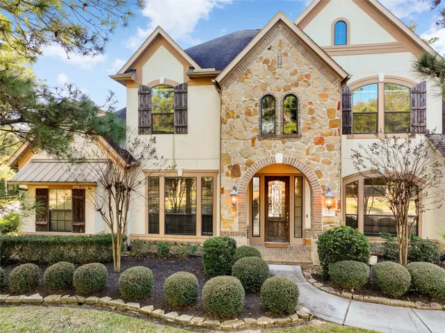 a view of a brick house with large windows