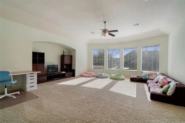 a living room with furniture and large windows